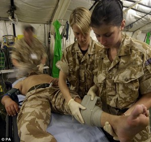 Frontline care: Army medics treat an injured soldier at Camp Bastion.